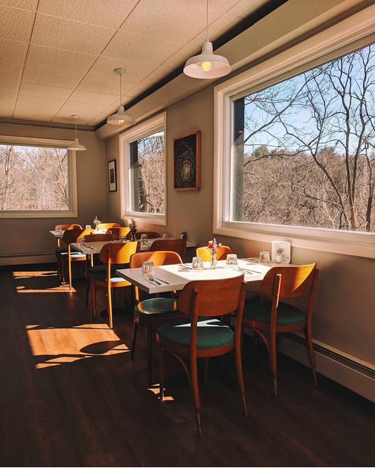 Afternoon light across the tables and amber chairs in Gracie’s dining room